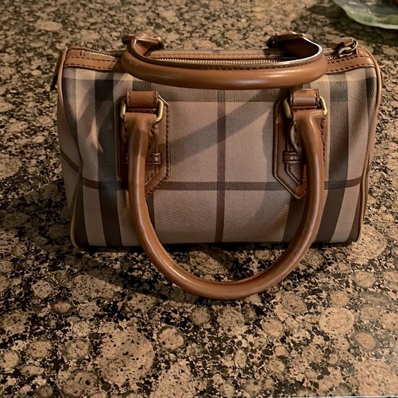 Burberry Handbags - Burberry purse. In perfect condition. No defects. Many shades of brown
